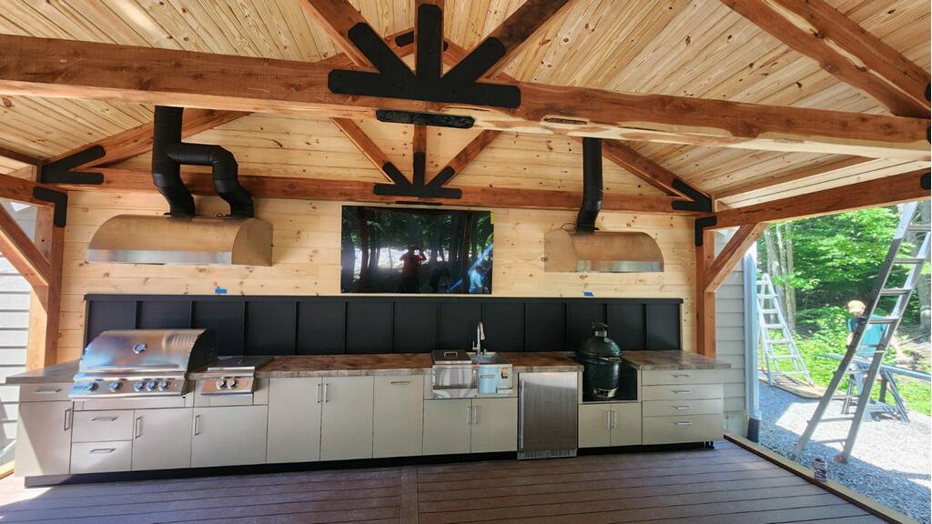 Outdoor kitchen pavilion with decorative truss and steel plates