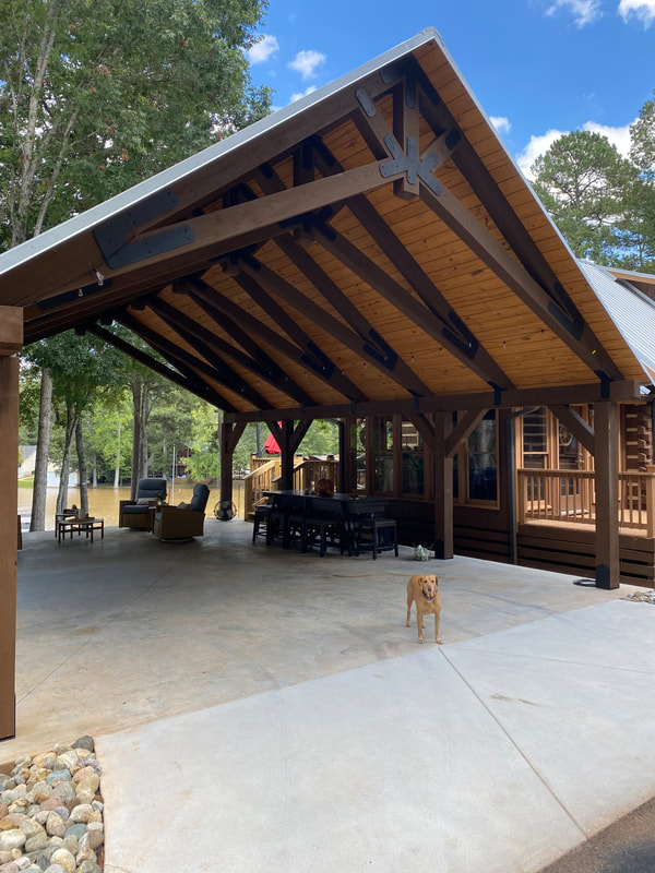 Custom heavy timber lakeside pavilion with king-post trusses