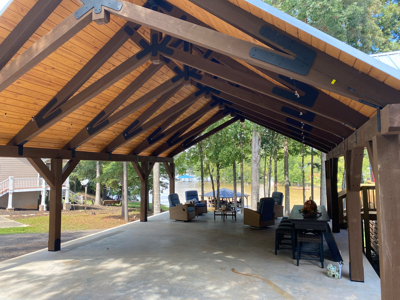 Lakeside pavilion with king-post trusses and steel plates