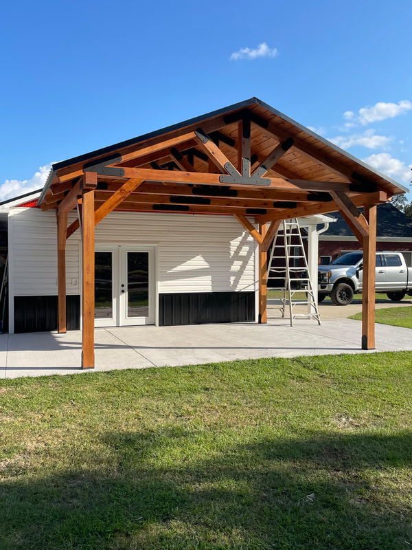 Attached Cypress pavilion with king-post truss and steel plating