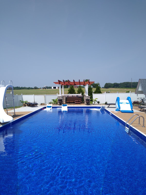 Cedar pergola overlooking inground pool
